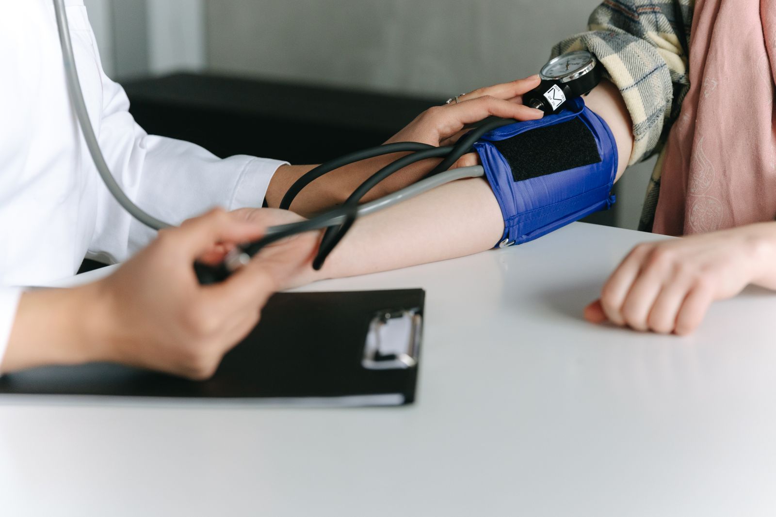 Woman patient having her blood pressure checked during a women's health consultation