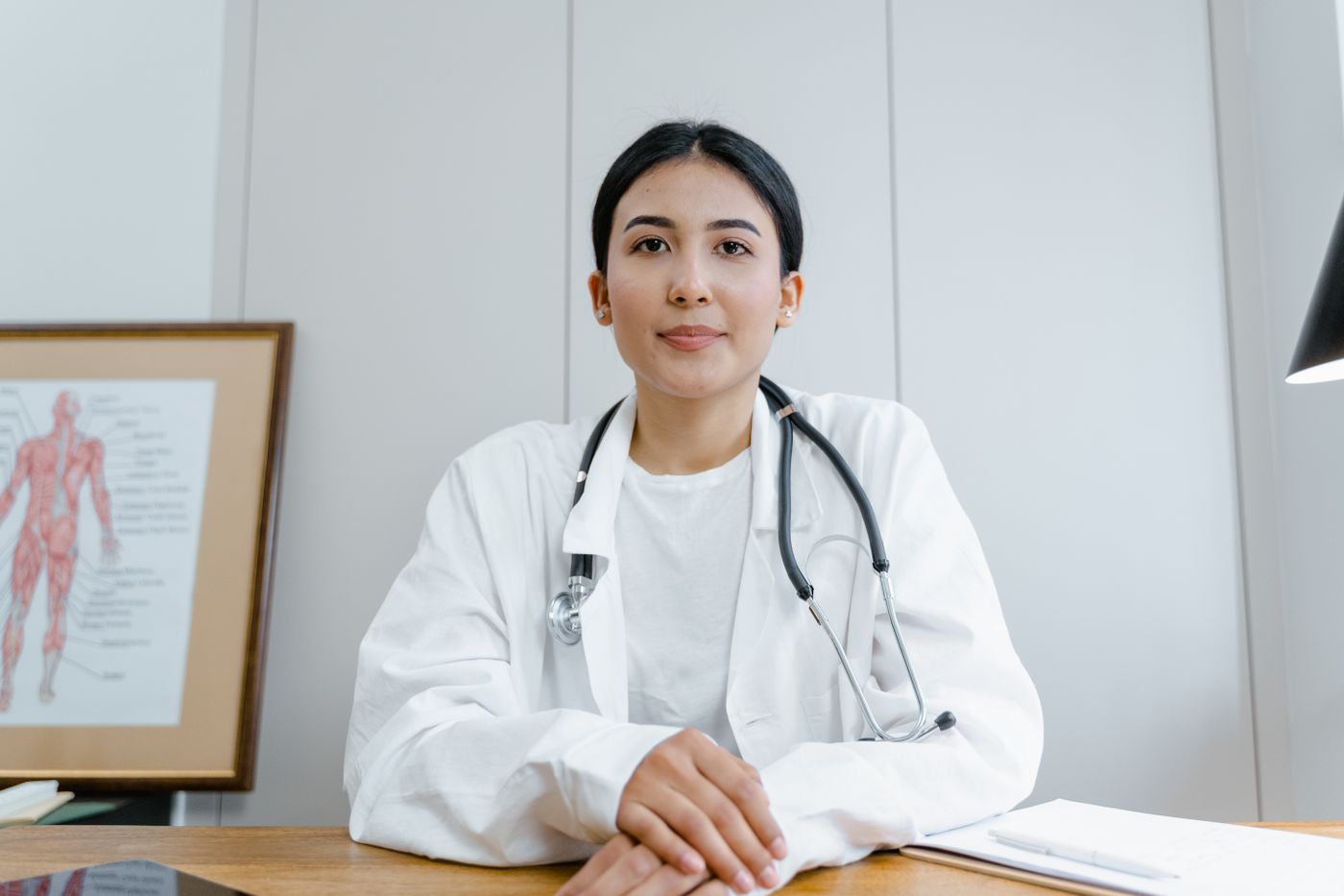 A doctor sitting calmly at her desk in a small practice, the kind of clinician the new wave of AI tools is built to make faster