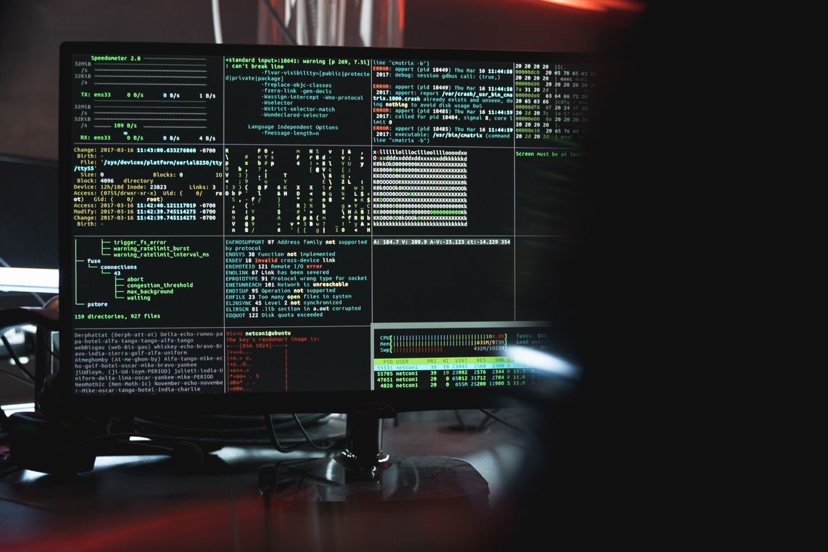 A monitor showing system logs and code, representing cybersecurity risk from AI tools in a medical practice