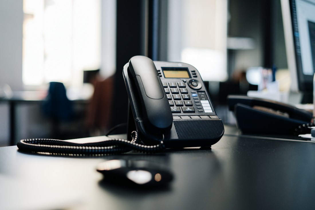 A desk phone sitting unanswered in a medical office, the kind of missed call an answering service or AI receptionist is meant to catch