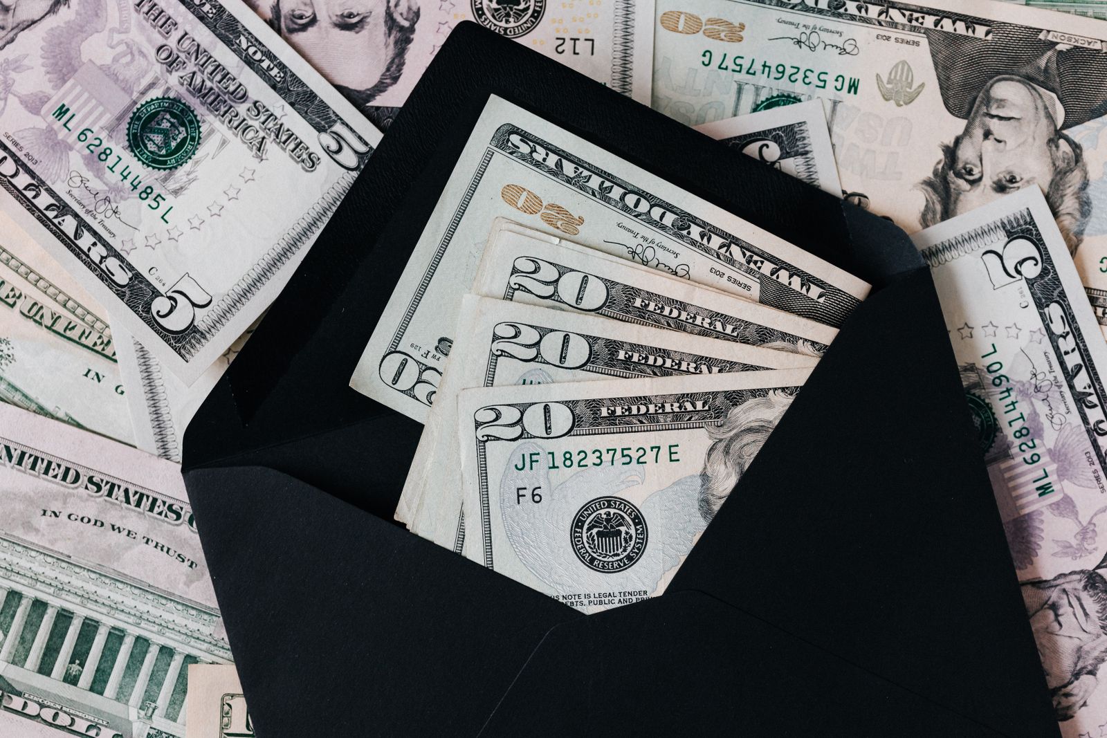 Cash in an envelope, a stand in for a medical practice ad budget and the real cost of acquiring a patient through Google Ads versus SEO