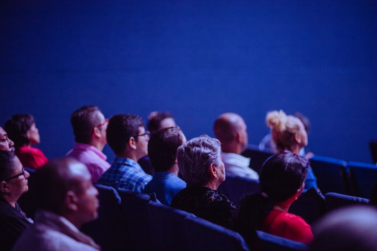 A diverse crowd of people seated at a local community event, the kind of audience a medical practice hopes to reach when it sponsors a 5k, festival or fundraiser