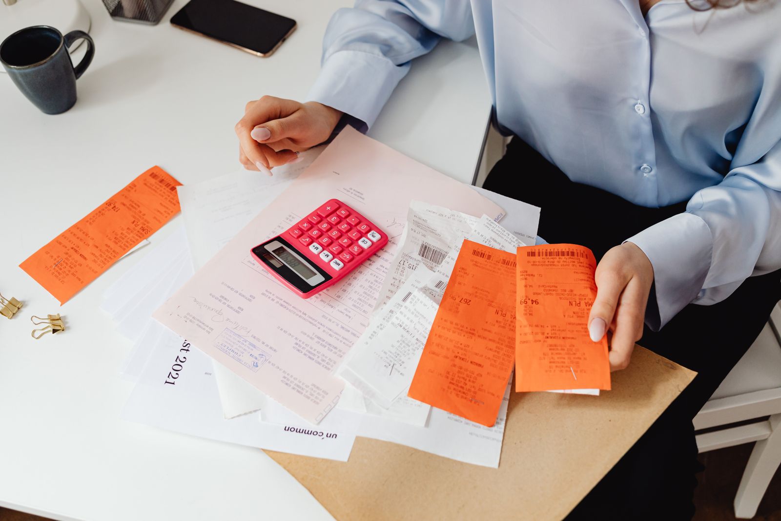 A patient sitting at a table reviewing a confusing medical bill with a calculator, frustrated at an unexpected charge