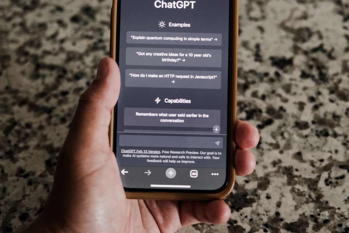 A patient holding a phone showing an AI chat assistant, representing an AI agent booking a medical appointment for the patient