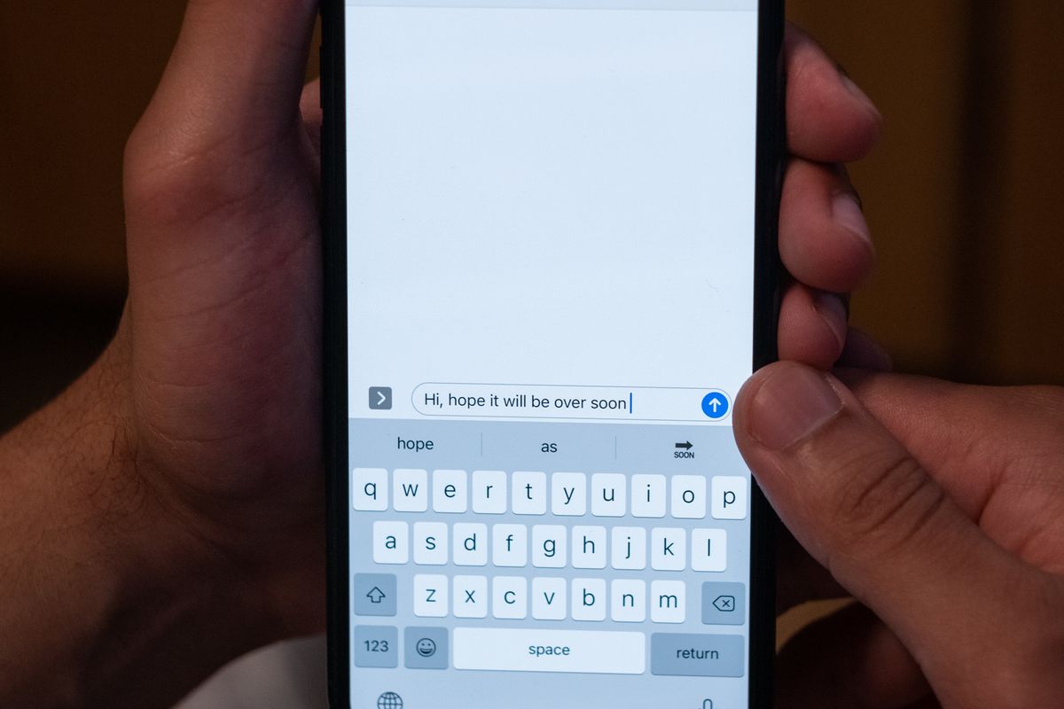 A patient texting on a smartphone to book an appointment with a medical practice