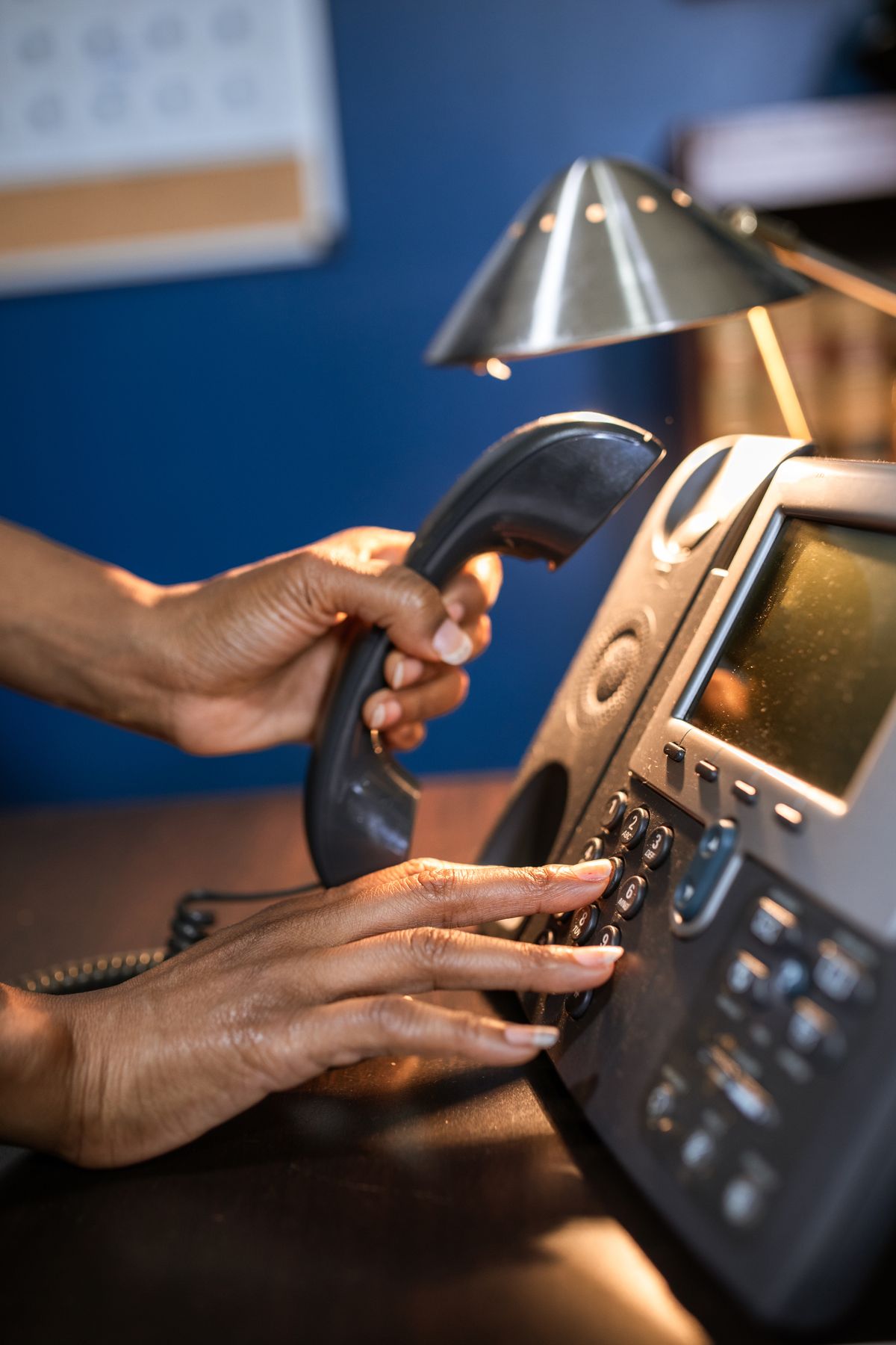 Close up of a hand dialing a phone, the kind of inbound call a medical practice can measure with a call tracking number without hurting local SEO