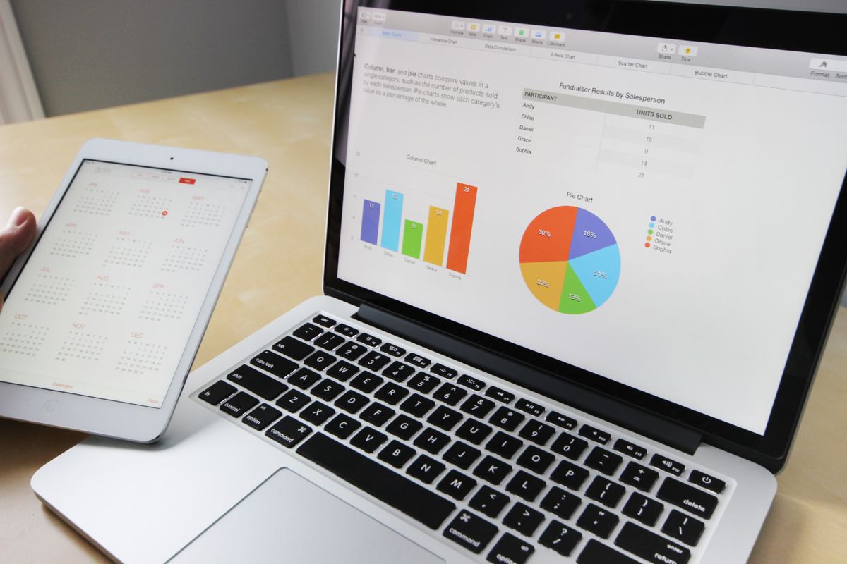 A laptop showing charts and analytics, the paid and organic search data a medical practice tracks side by side