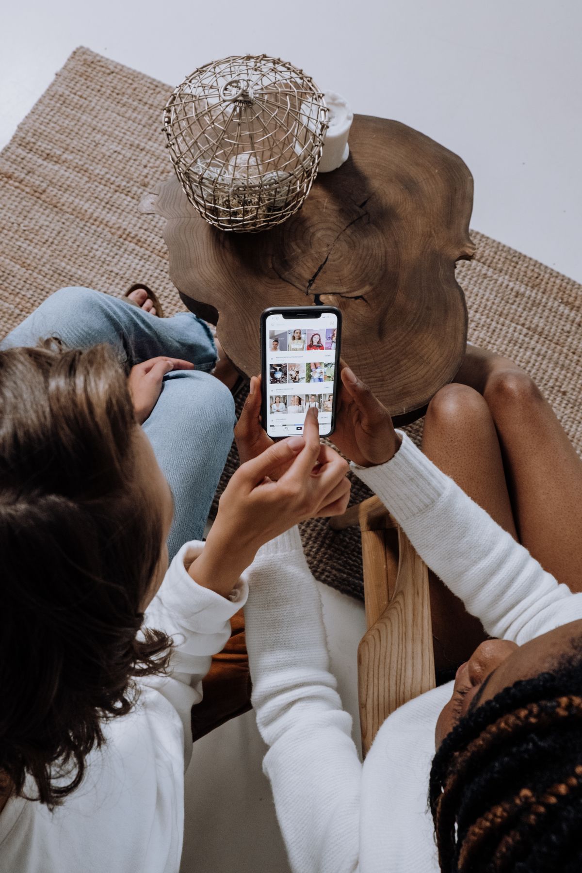 Two people watching short video content on a phone, representing Instagram Reels for a medical practice
