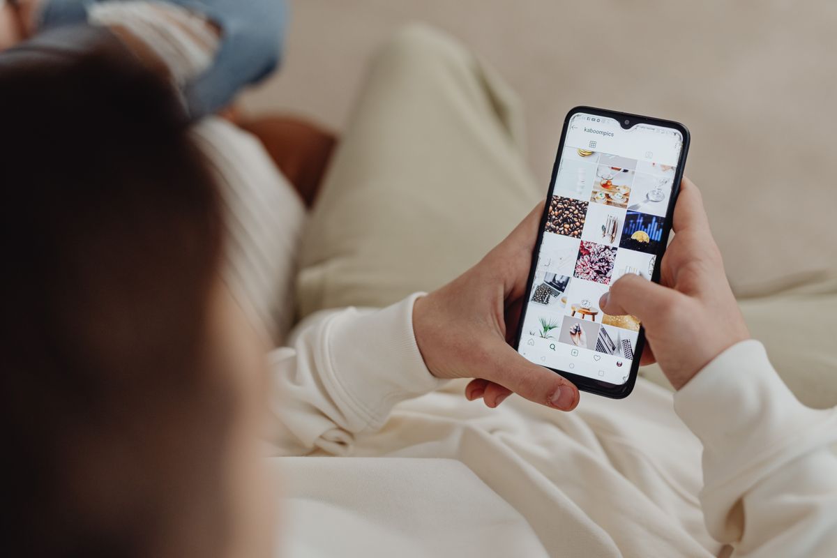 A patient checking a medical practice's social media on a smartphone before booking an appointment