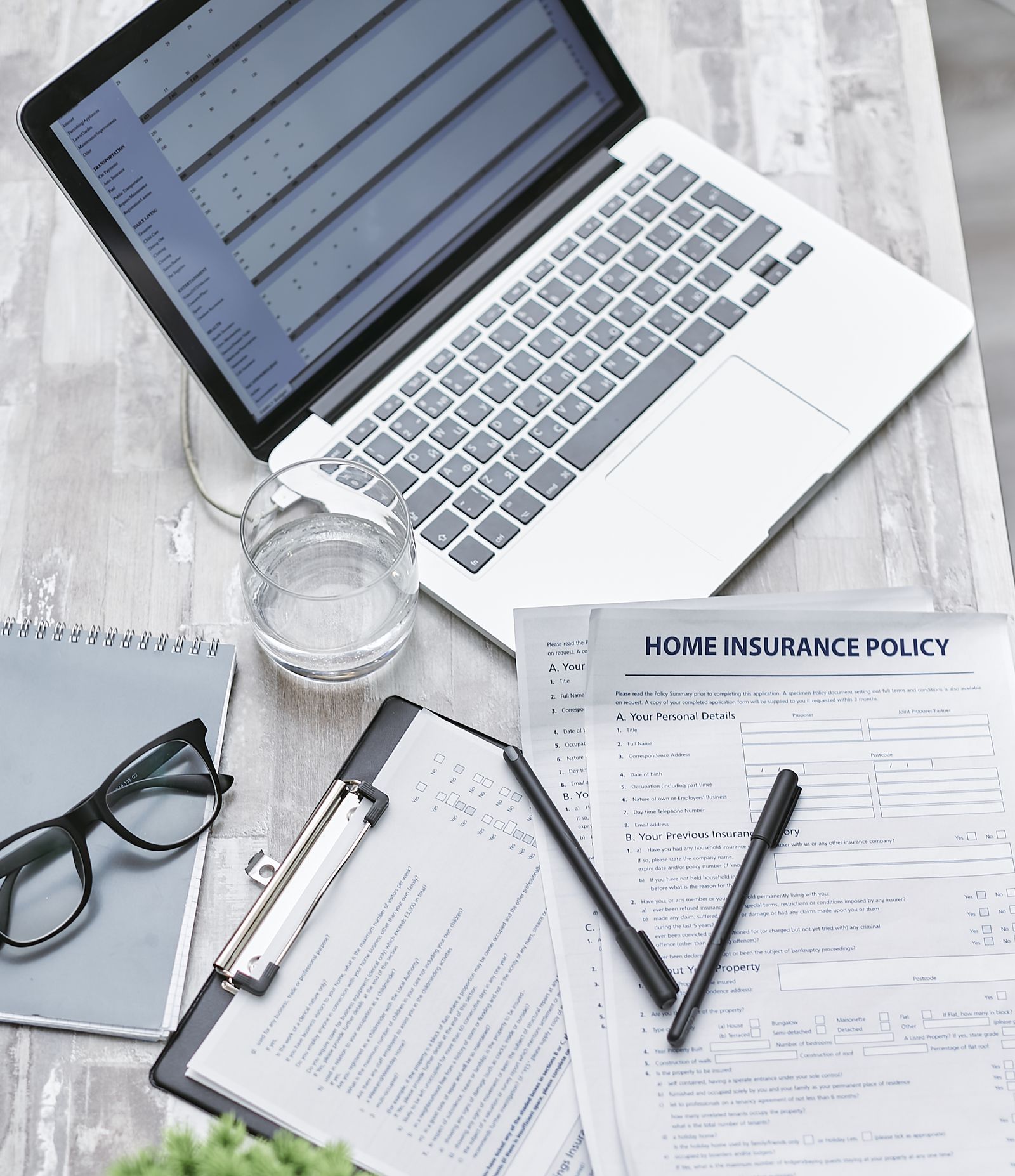 Patient reviewing a health insurance policy next to a laptop while choosing an in network doctor