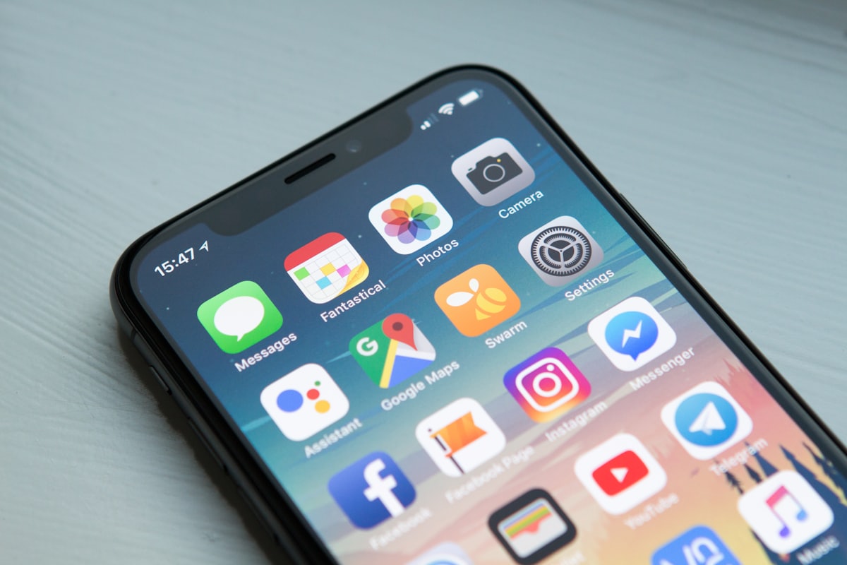 A phone showing Google Maps and social apps, the way a patient reads a medical practice's reviews before booking