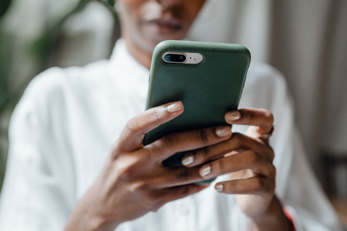 A prospective patient reading medical practice reviews on a phone before booking an appointment