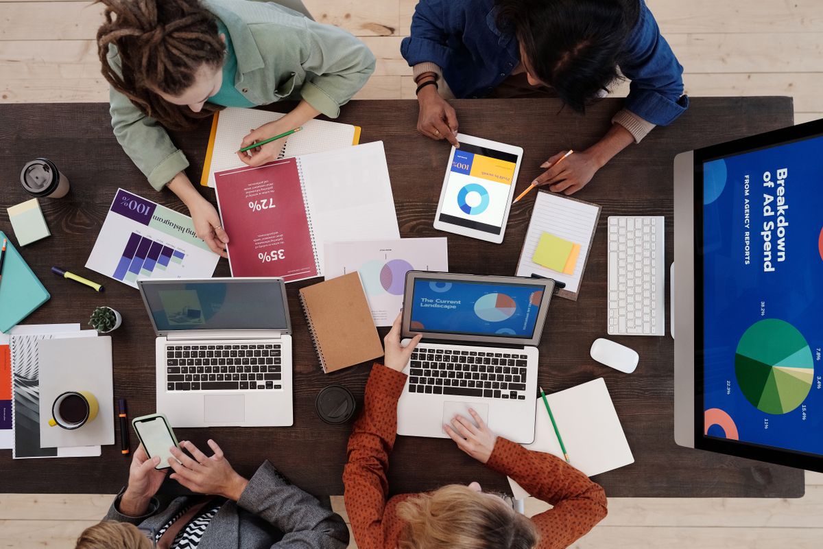 A marketing team reviewing search results and page copy for a medical practice on laptops