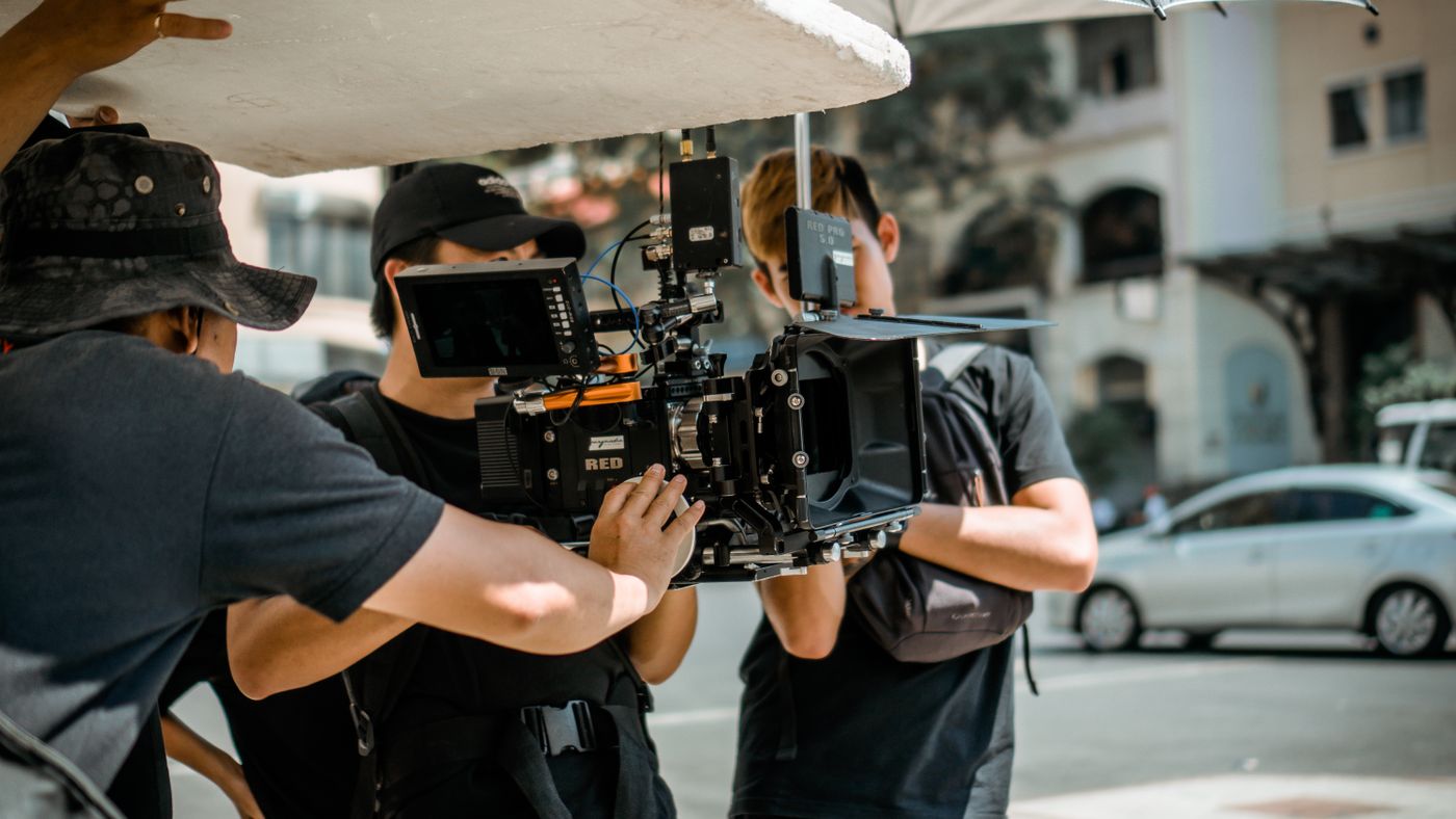 A film crew recording video content on a professional camera, illustrating video ads for medical practices