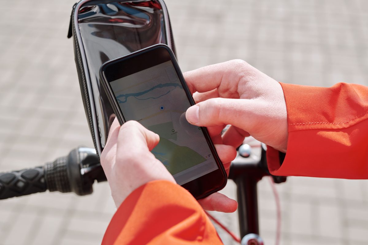 A patient using a smartphone to search for a doctor near me on a map