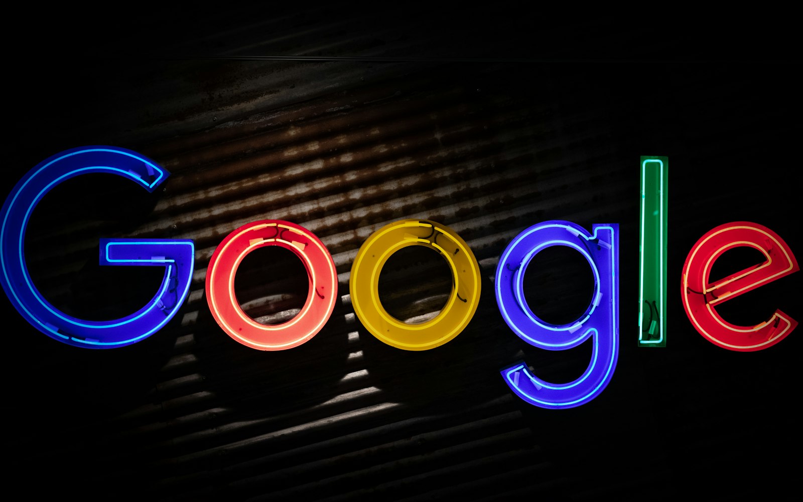 Google logo in colored neon, standing in for the Google Business Profile that decides which medical practice a patient sees first