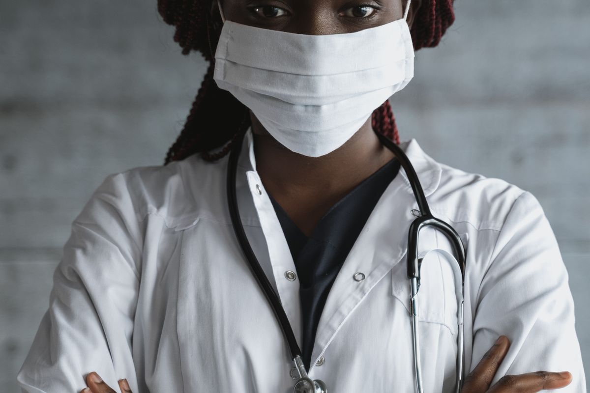 A doctor in a white coat with a stethoscope, the kind of real, credentialed provider that gives a medical website its EEAT