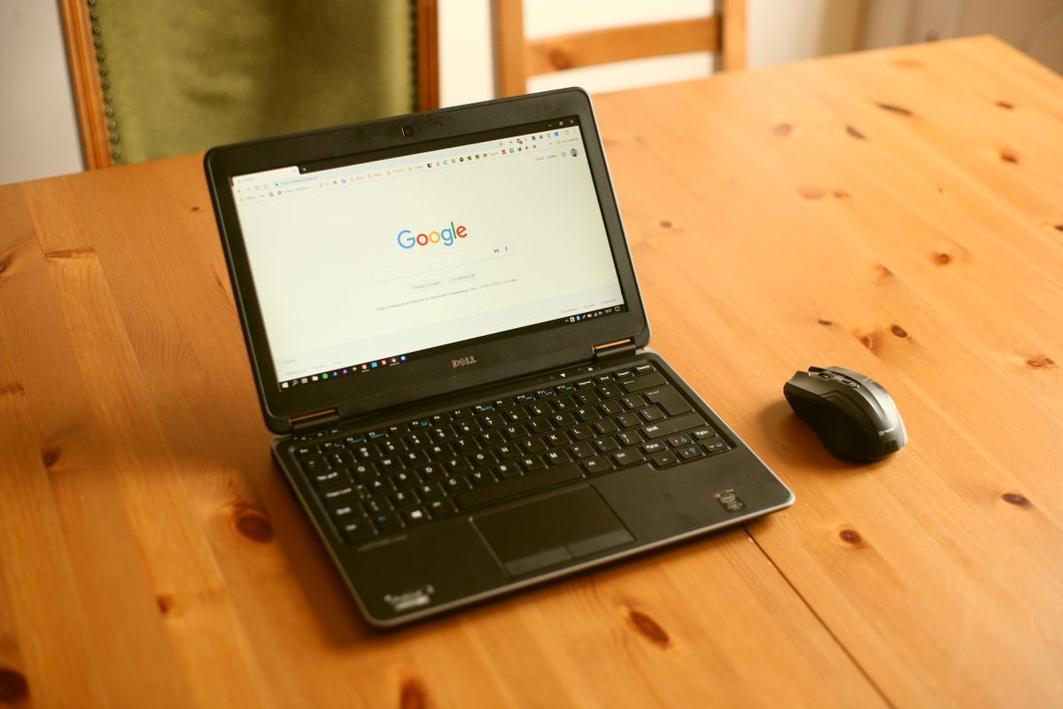 A laptop open to a search engine on a wooden desk, representing how Google and AI decide what to say about a medical practice