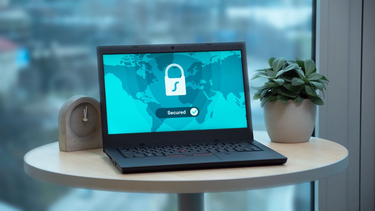 A laptop showing a padlock and a secured badge, representing patient data privacy for a medical practice website