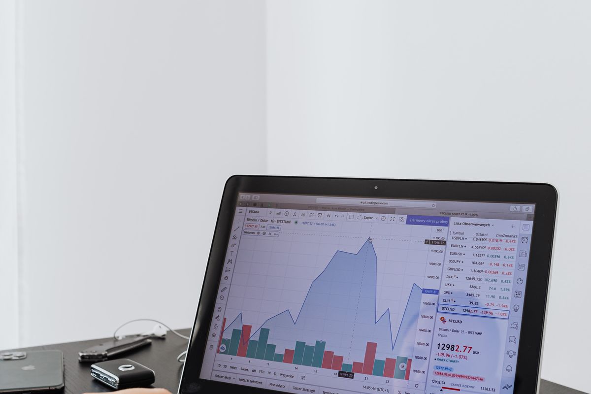 A person reviewing marketing performance data on a laptop, weighing Google Ads against SEO for a medical practice