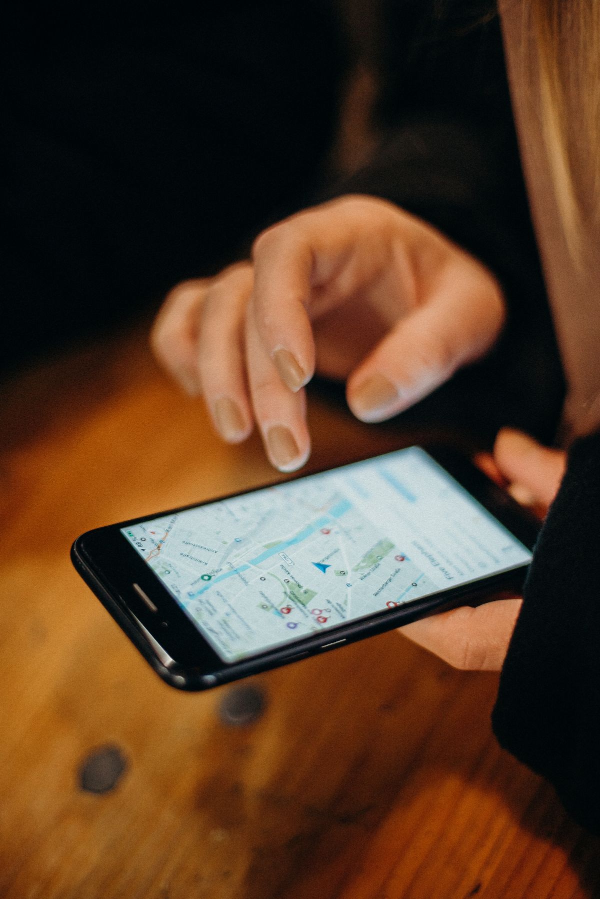 A patient browsing a medical practice on Google Maps on a phone, looking at a map with location pins