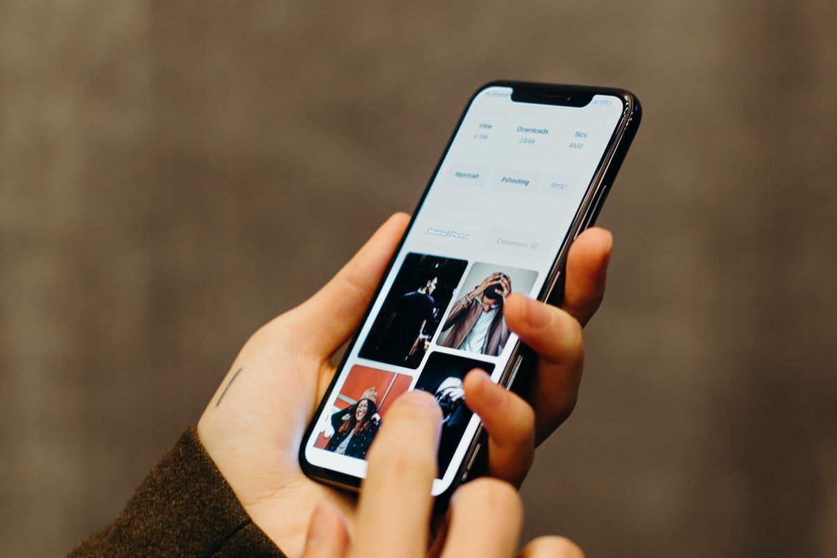 A person holding a phone, the moment a new patient reaches out to a medical practice and waits for a response