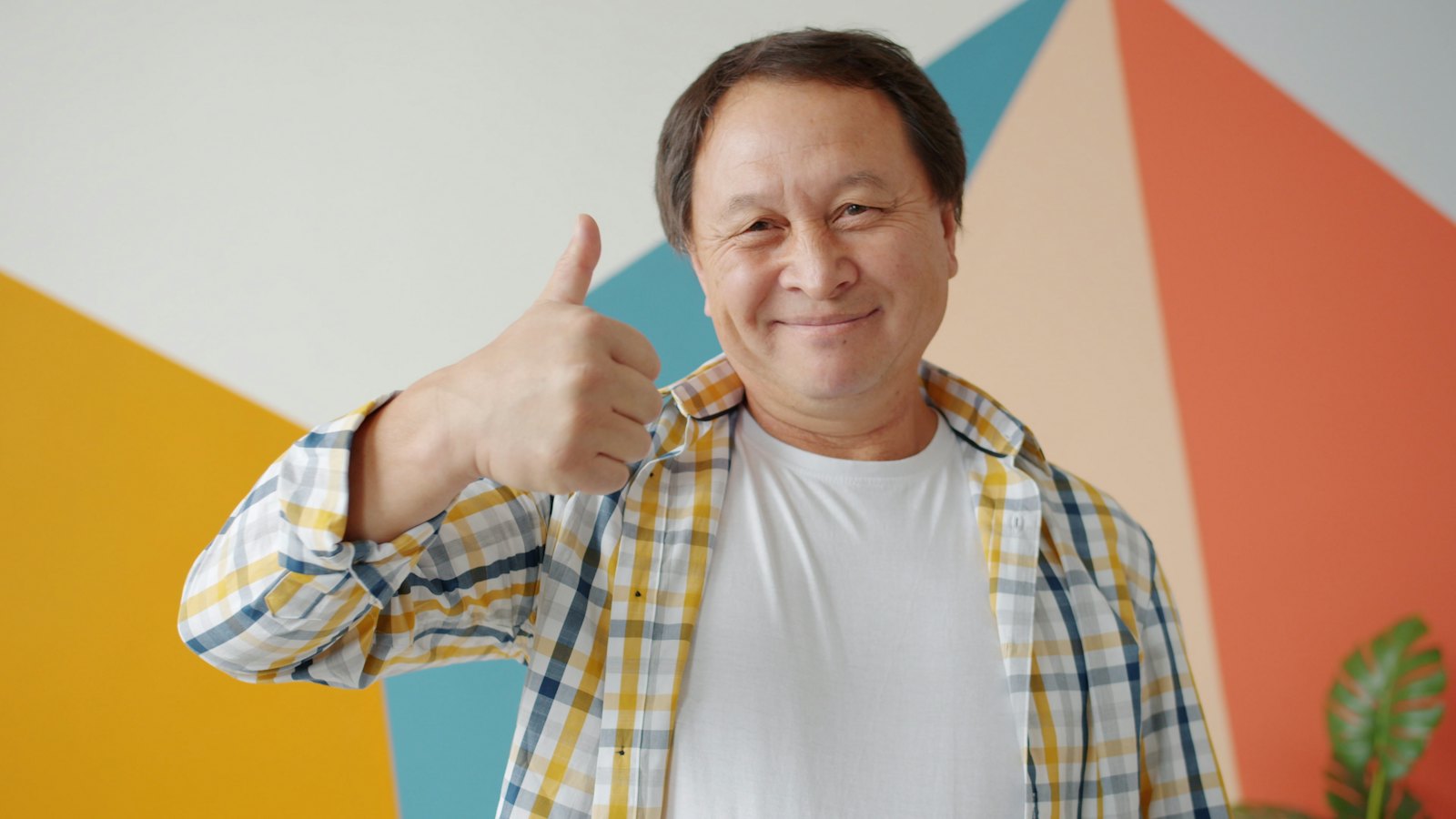 A happy older patient giving a thumbs up, the kind of patient who leaves a positive Google review for a medical practice