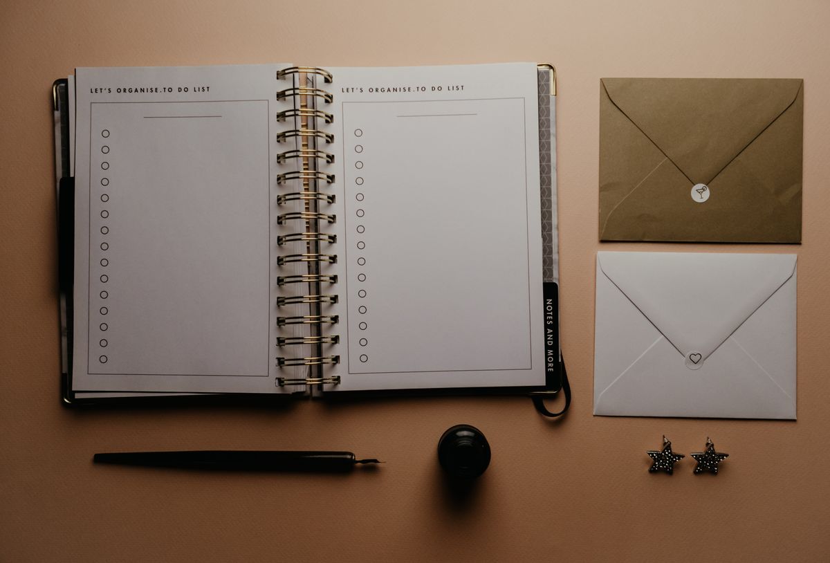 An open planner with a checklist and small stars, the kind of steady monthly routine that keeps fresh Google reviews coming in for a medical practice
