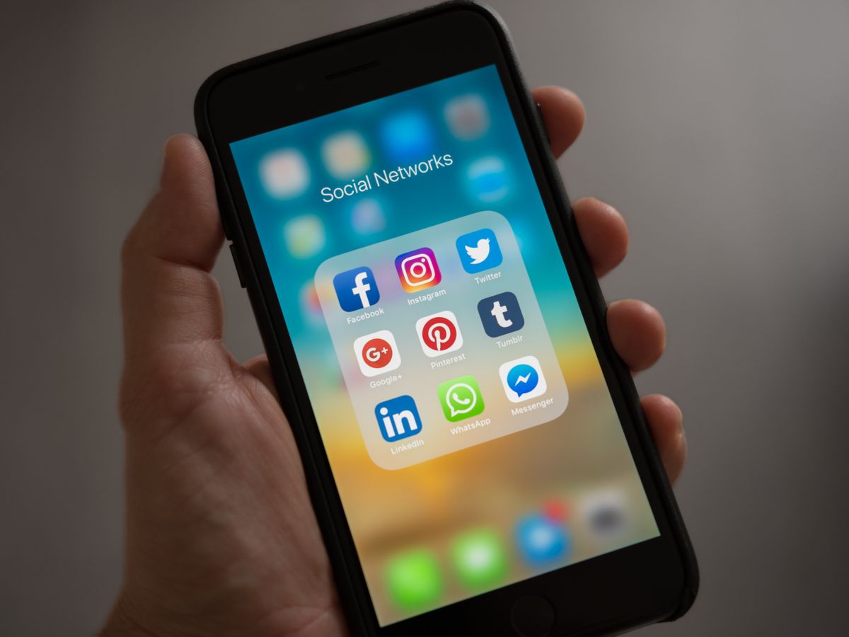 A person holding a phone open to the Instagram app, illustrating the follower count question for a medical practice
