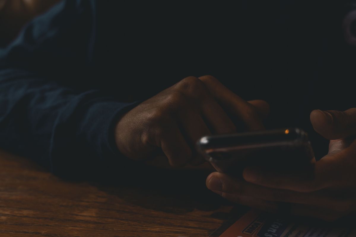 A patient reading doctor reviews on a smartphone before booking an appointment