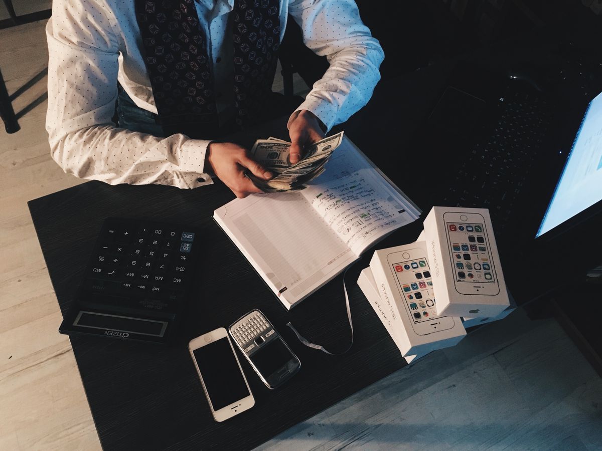 A calculator resting on financial documents, used to work out how much a healthcare marketing agency costs a medical practice each month