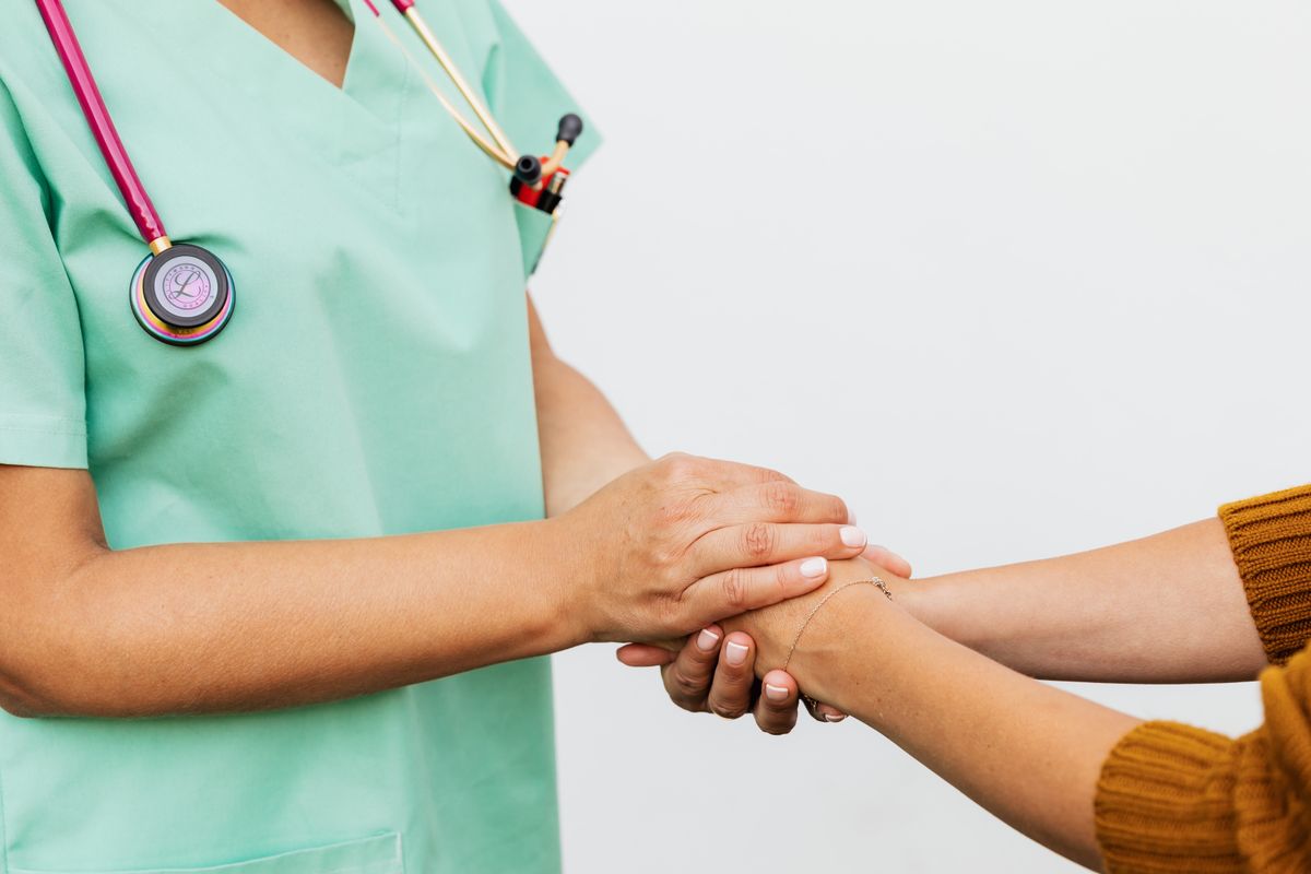 A doctor and patient shaking hands, the moment a patient chooses a practice on trust rather than the lowest price