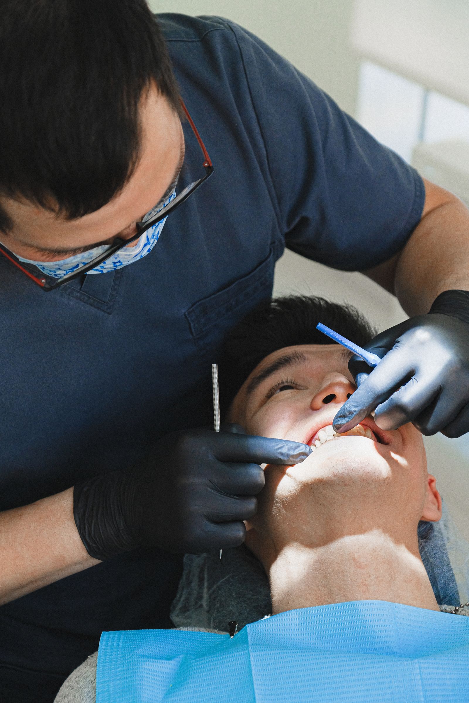 Dentist treating a patient in an independent dental practice chair