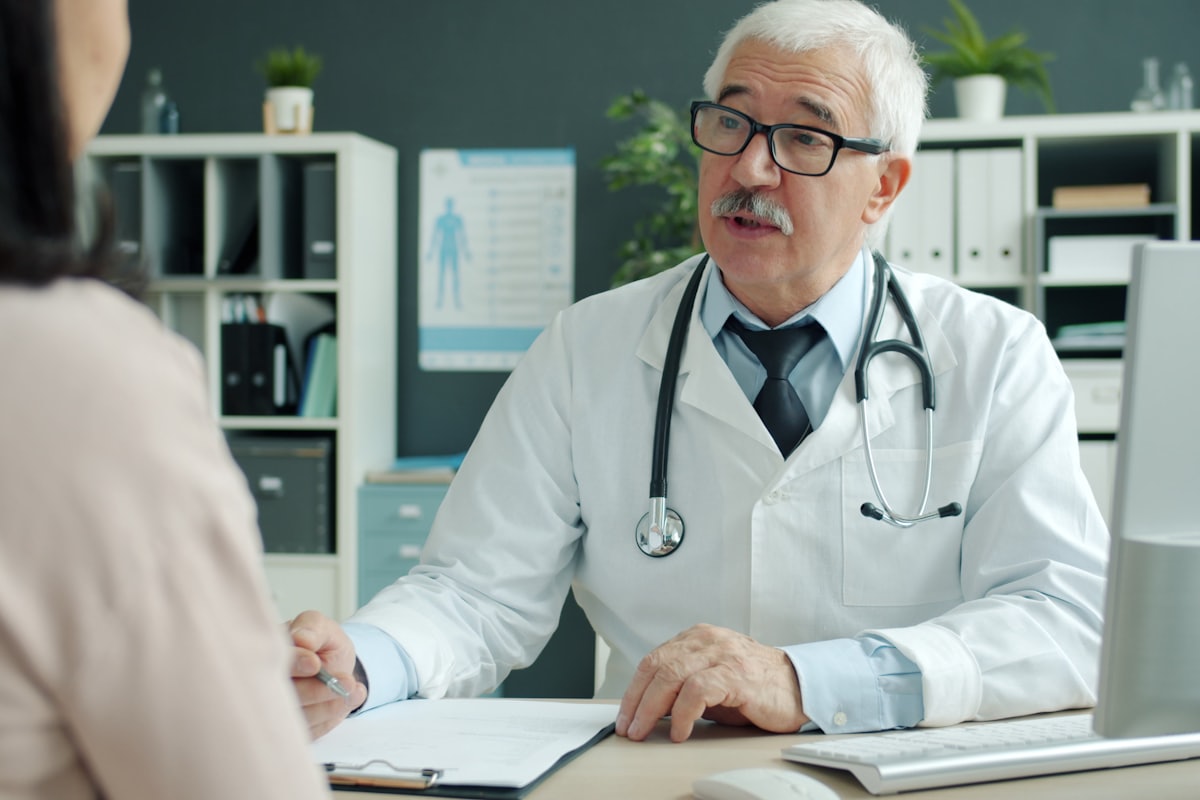 A doctor talking one on one with a single patient in an office, the kind of patient a practice is truly built to help