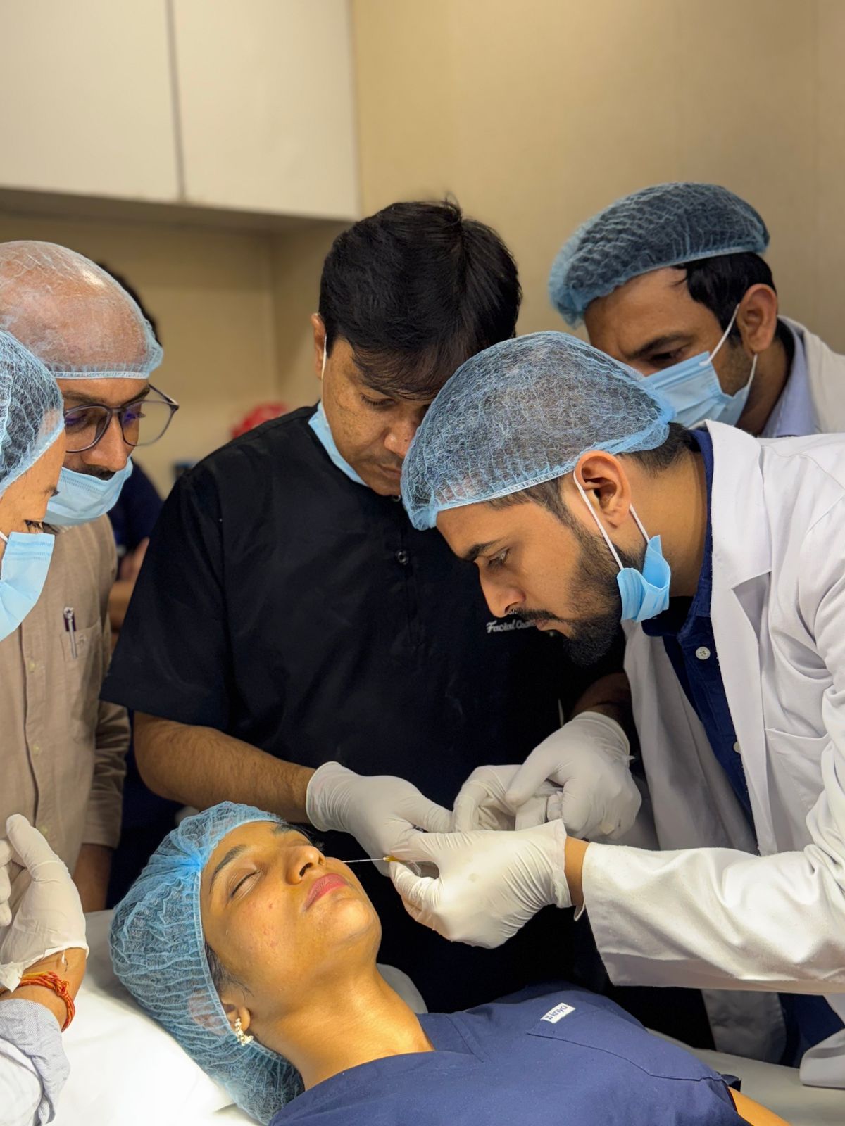 A med spa provider performing an aesthetic facial treatment on a client in a clean clinical setting