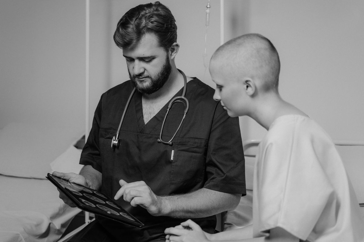 A doctor showing a patient services on a tablet, closing the gap on treatments the patient did not know were offered