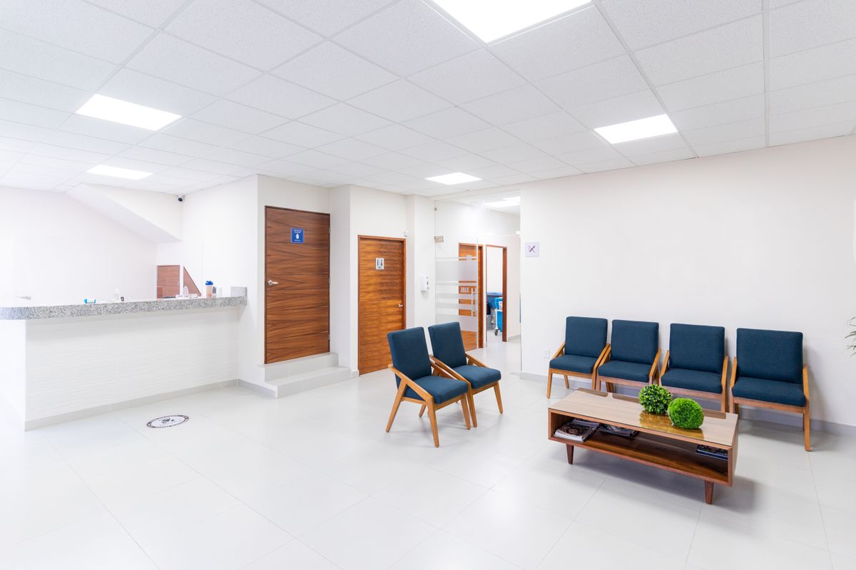 A clean, empty medical practice waiting room on opening day, the kind of brand new office that has no online reviews yet