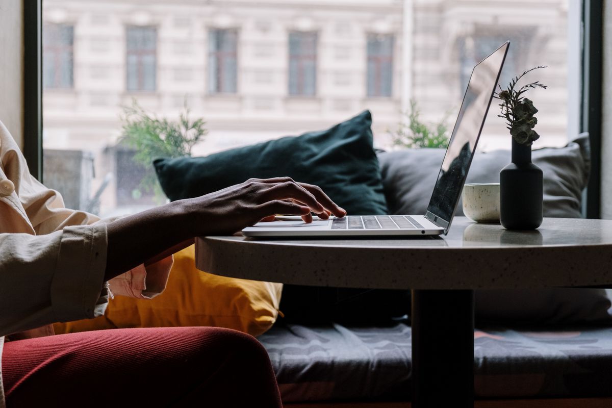 A person booking an appointment online from a laptop at home, the moment a practice either captures or loses a new patient