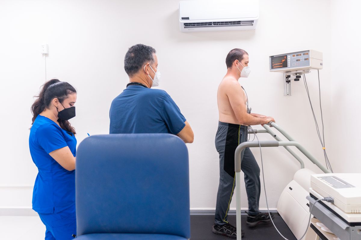 A cardiologist examining a patient during a cardiac stress test at a heart clinic
