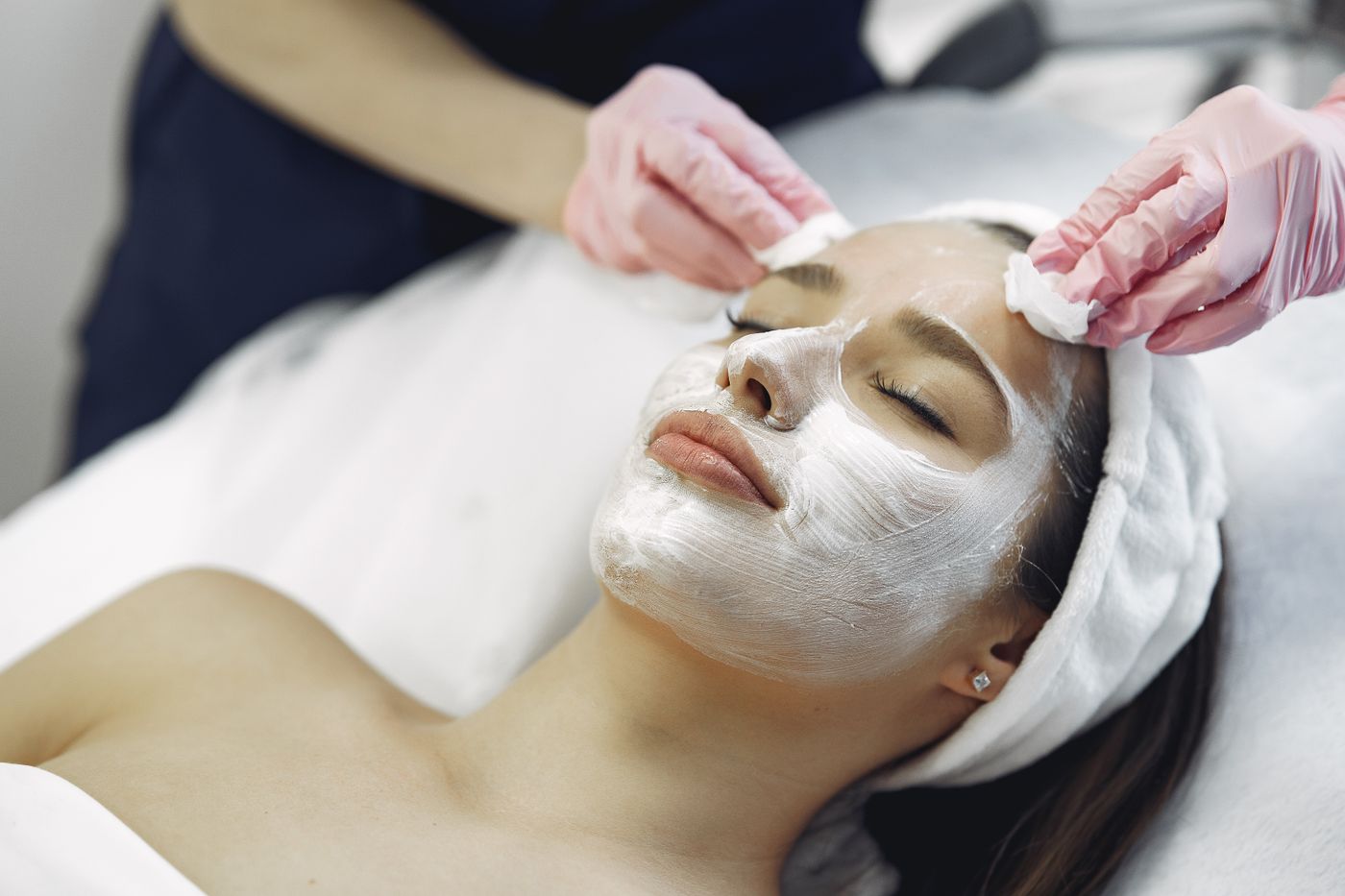 A dermatology patient receiving a professional skin treatment, representing medical and cosmetic dermatology care