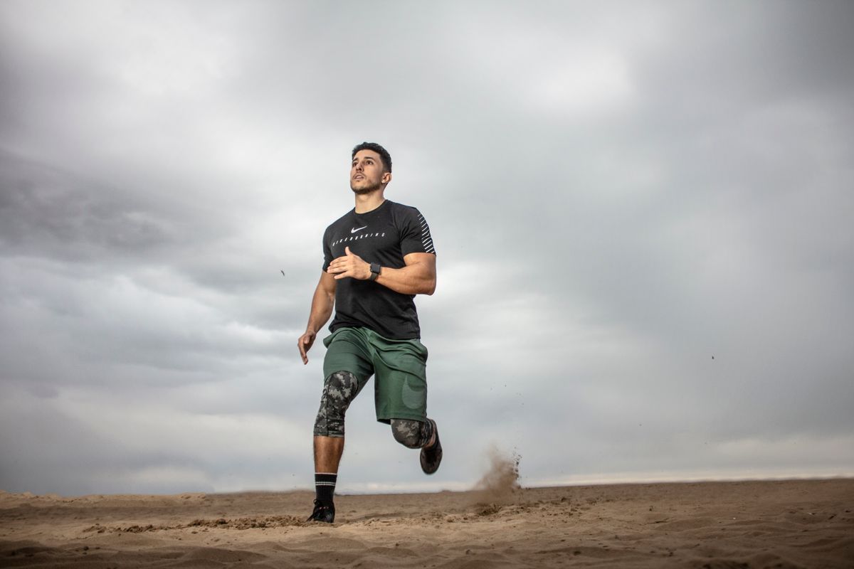 An active adult runner training outdoors, the kind of weekend athlete a sports medicine practice treats