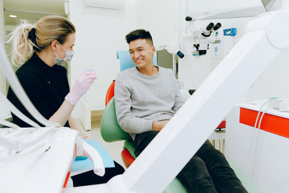 A relieved patient smiling in the dental chair after being seen the same day at an emergency dentist