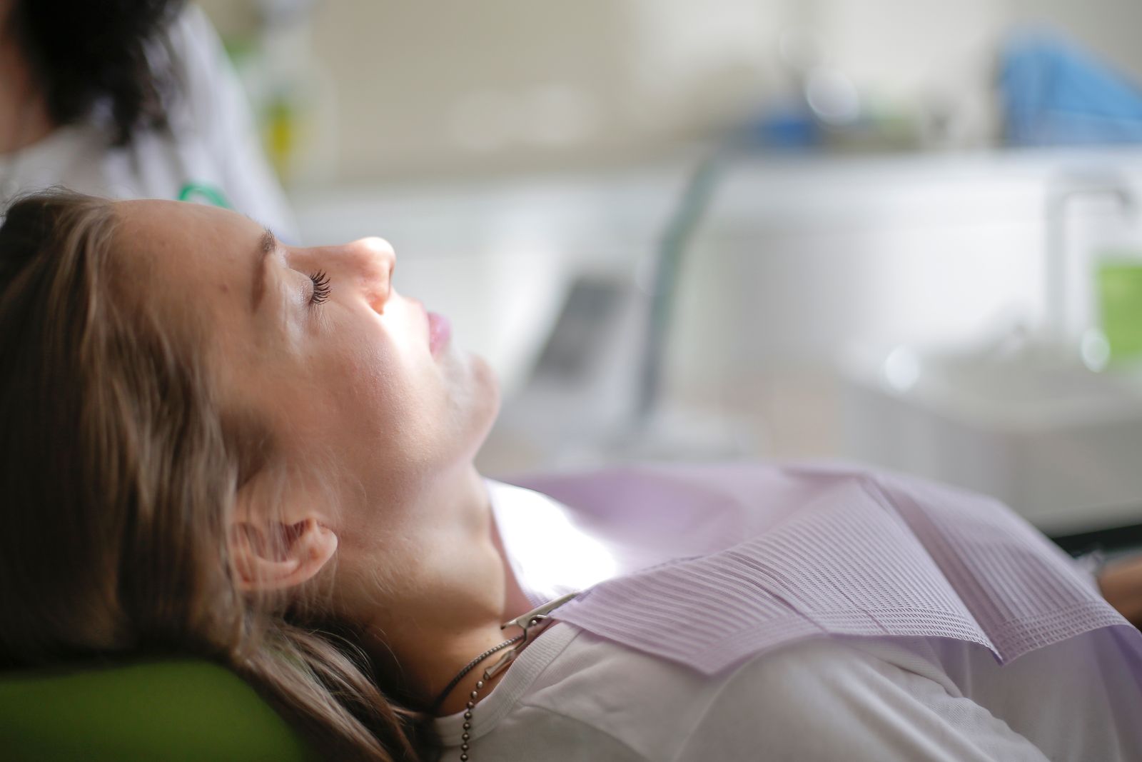 A patient reclined in a dental chair during an examination, illustrating endodontist practice marketing and root canal patient care