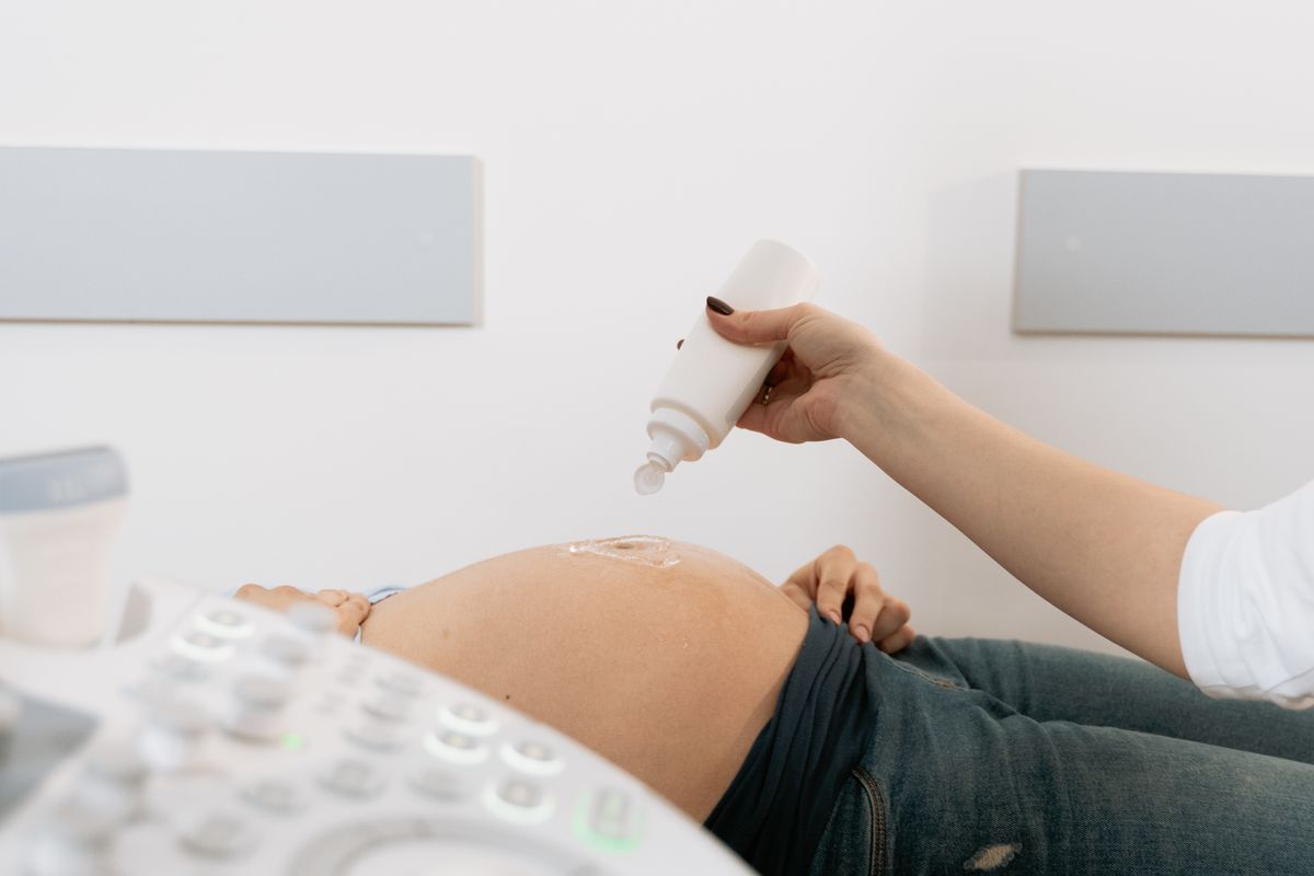 An OB/GYN preparing a pregnant patient for an ultrasound, the kind of trusted moment good marketing leads to