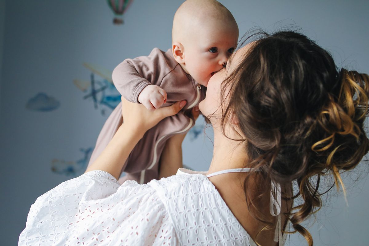 New mother holding her baby, the kind of family a medical practice can win for years with the right marketing