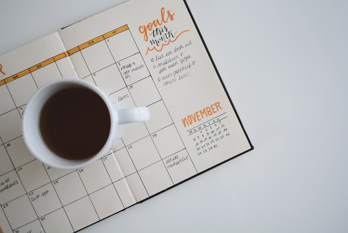 An appointment calendar and planner on a desk, representing empty slots from patient no shows at a medical practice