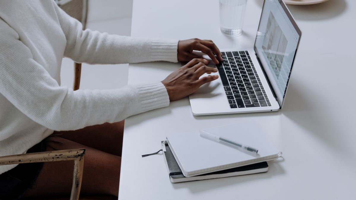 Patient at a laptop researching a new doctor online, the moment where AI now answers first