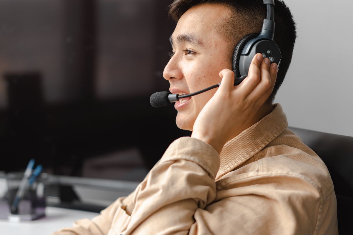 A front desk agent on a headset answering a patient call, the kind of first conversation AI is now starting to handle for medical practices