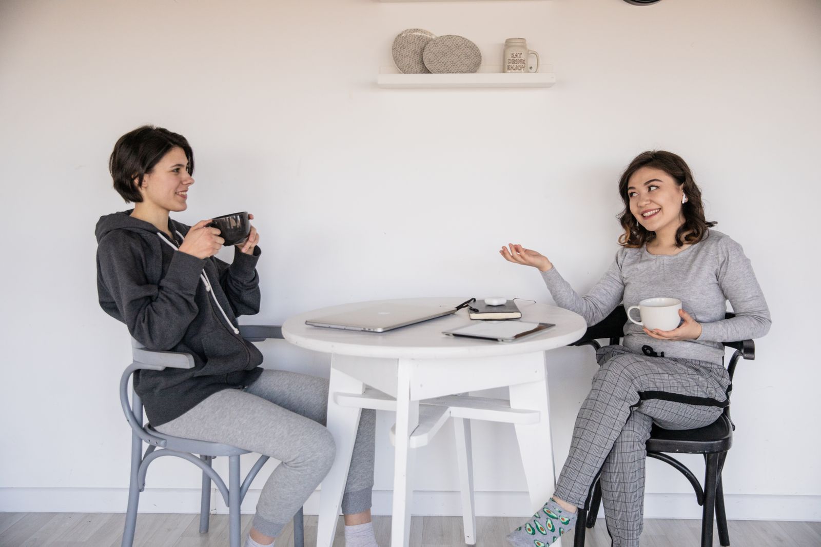 Two friends chatting over coffee, the kind of personal recommendation that still sends patients to a doctor but now gets checked online first