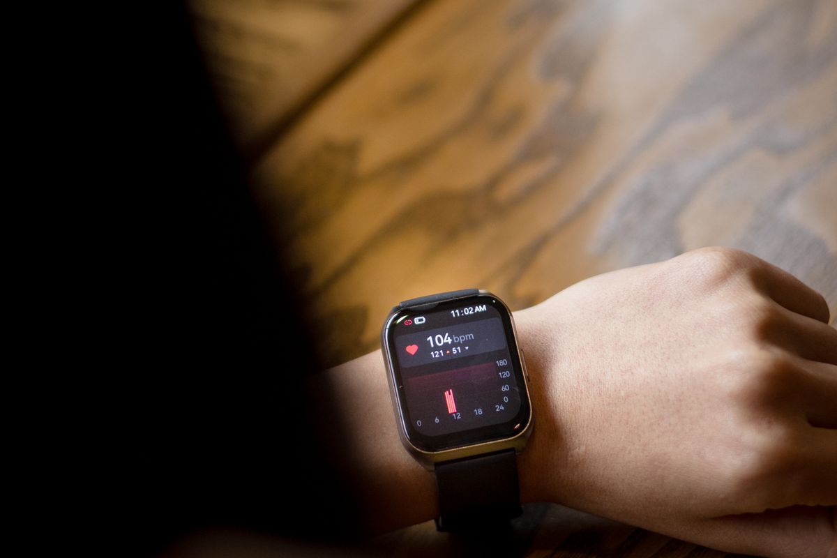 A person checking the heart rate shown on their smartwatch, the kind of wearable data patients now bring to a medical practice